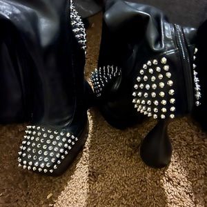 Long black faux leather boots with silver studs